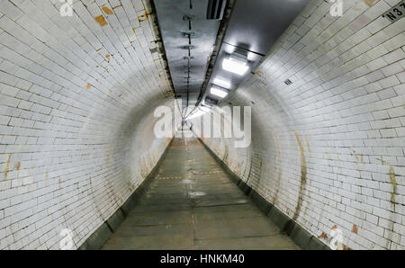 Greenwich foot tunnel. Old tunnel built in 1902 to cross from north to south of the River Thames and still in fulll operation. Stock Photo