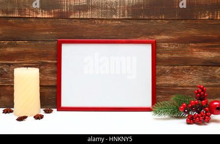 Red Photo frame in interior with candle and wooden background Stock Photo