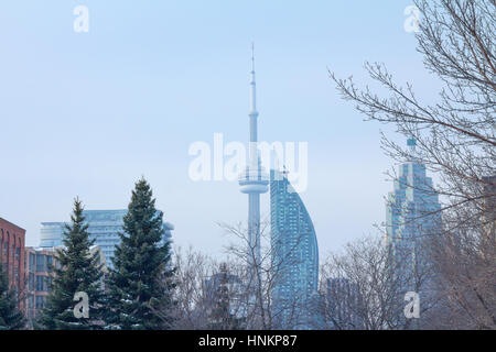 TORONTO, CANADA - DECEMBER 21: CN tower (Canadian National) in a cold morning of winter seen from a residential district of Toronto, Ontario, Canada   Stock Photo