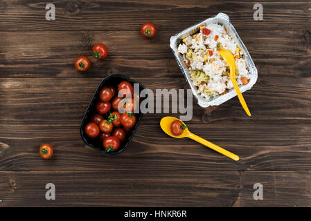 Cherry-tomatoes lying in black bowl Stock Photo