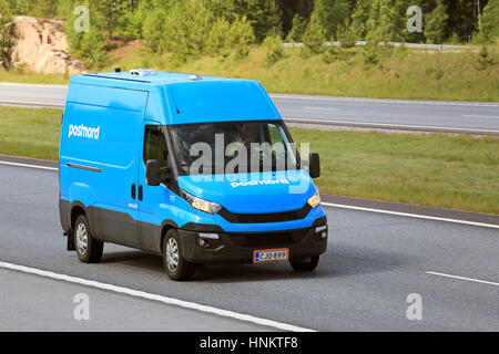 PAIMIO, FINLAND - JUNE 3, 2016: Blue Iveco delivery van of Postnord at speed on freeway at summer. Stock Photo