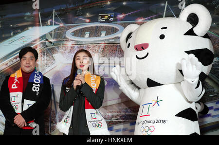 Former South Korean figure skater Kim Yuna, center, with mascot Soohorang during a ceremony to unveil the Olympic torch for the PyeongChang Olympic torch relay at the Gangneung Hockey Center February 9, 2017 in Gangwon-do, South Korea. The ceremony marks the one year countdown before the opening ceremony for the 2018 Winter Olympic Games. Stock Photo