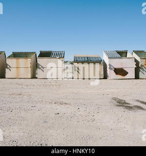 Row of garbage and recycling containers in desert Stock Photo