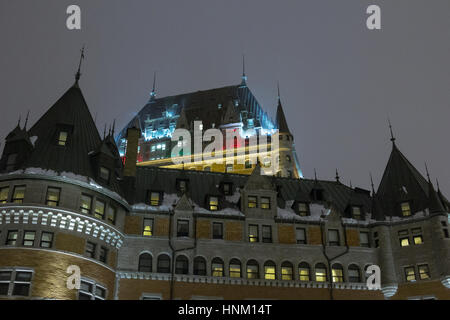 View of Frontenac Castle (Chateau de Frontenac, in French) in winter under icy snow in the night. The Château Frontenac is a grand hotel in Quebec Cit Stock Photo