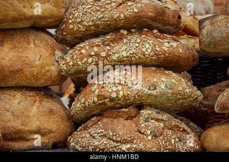 A stack of artisan seeded bread loaves - detail Stock Photo