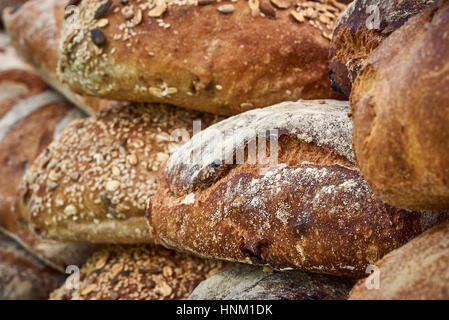 A stack of artisan seeded bread loaves - detail Stock Photo