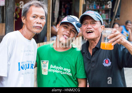 Men in slum by Bangkerohan River, Davao, Davao Del Sur, Philippines Stock Photo