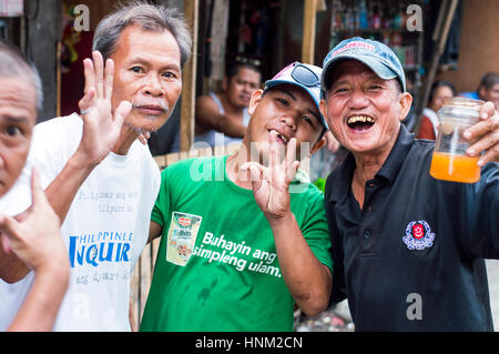 Men in slum by Bangkerohan River, Davao, Davao Del Sur, Philippines Stock Photo