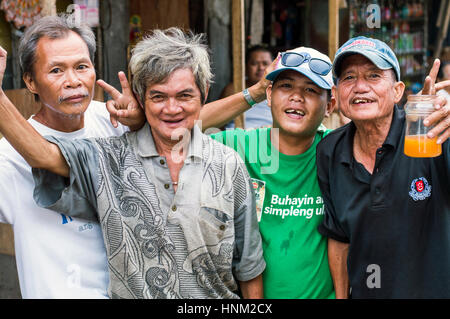 Men in slum by Bangkerohan River, Davao, Davao Del Sur, Philippines Stock Photo