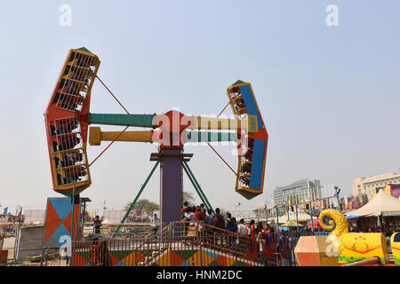 Visitors are enjoying at big swings/giant wheel in Surajkund craft fair 2017. Stock Photo