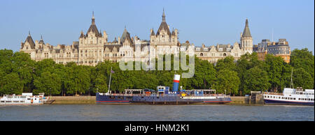 Panoramic view of Victoria Embankment early one morning in Summer. Includes the Thames River, the buildings of Whitehall and restaurant entertainment Stock Photo