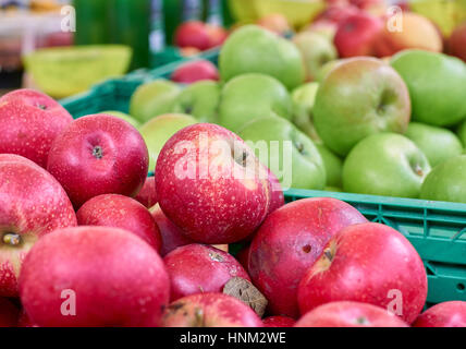 Rustic red and green apples on a market stall detail Stock Photo