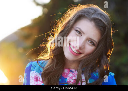Happy young woman walking in a summer park Stock Photo