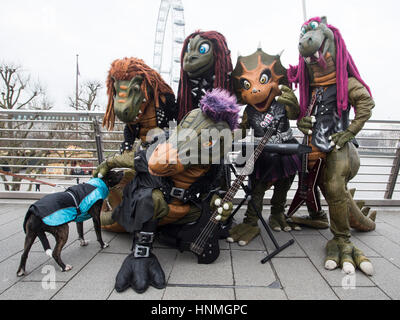 London, UK. 14 February 2017. Finnish heavy metal dinosaur band Hevisaurus busk on Golden Jubilee Bridge and the Southbank ahead of their London premiere in the Royal Festival Hall on 15 February, as part of Southbank Centre's Imagine Children's Festival (until 19 February). Stock Photo