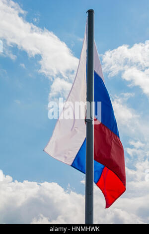 Russian flag on the background of the beautiful sky Stock Photo