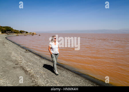 A Female Tourist Walking On A Beach, Lake Langano, Oromia Region, Ethiopia Stock Photo