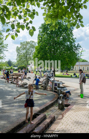 FRANKFURT, GERMANY - May 23, 2016: kids are playing inside the palmengarten in Frankfurt, Germany. The Palmengarten is one of two botanical gardens in Frankfurt and the largest garden of its kind in Germany. Stock Photo