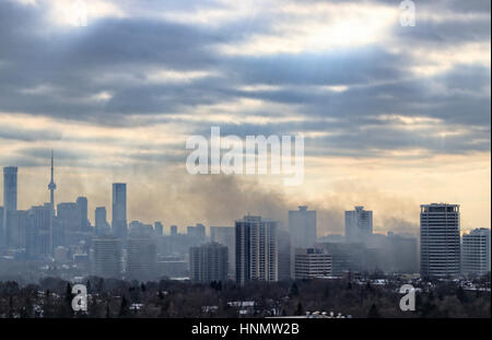 Toronto, Canada. 14th Feb, 2017. Massive smoke spreading into the sky after 6-alarm fire broke out from historic Badminton & Racquet Club of Toronto on St. Clair Avenue by Yonge Street in Deer Park community at 9:20 am on February 14, 2017. The image was taken at 2:24 pm and the smoke was still thick. Credit: CharlineXia/Alamy Live News Stock Photo