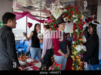 Mexico City. 15th Feb, 2017. People get married at a symbolic wedding held to celebrate Valentine's Day at the Latinamerican Tower, in downtown Mexico City, Mexico, on Feb, 14, 2017. Hundreds of people celebrated Valentine's Day by participating in symbolic weddings as part of the commemorative activities offered by the Latinamerican Tower. Credit: Paulina Negrete/ObturadorMX/Xinhua/Alamy Live News Stock Photo