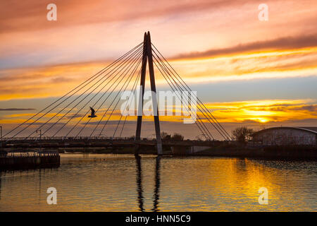 Southport Marine Lake, Merseyside, UK. 15th February 2017. UK Weather. Hues of Sunset after a warm February day. This busy highway connects Southport's Promenade and town centre with Ocean Plaza and Southport Beach as it crosses the Marine Lake. Areas of Southport's town centre have undergone major redevelopment in the last decade and this iconic structure provides a link from the town centre to the Esplanade. Credit; MediaWorldImages/Alamy Live News Stock Photo