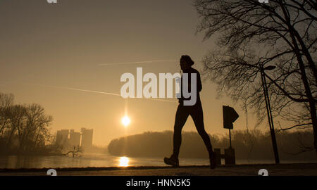 Berlin, Germany. 15th Feb, 2017. A man jogs along a path next to Rummelsburger Bay in Berlin, Germany, 15 February 2017. Photo: Paul Zinken/dpa/Alamy Live News Stock Photo