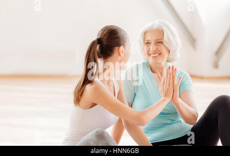 Happy nice women giving high five Stock Photo