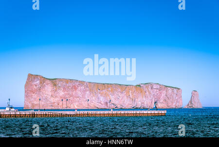 scenic view of Perce Rock in Gaspe Peninsula in St Lawrence river under a blue sky, Quebec, Canada Stock Photo