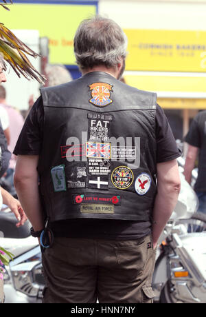 MOTORCYCLIST with his leader vest and brands 2015 at a biker gathering in Truro Cornwall Stock Photo