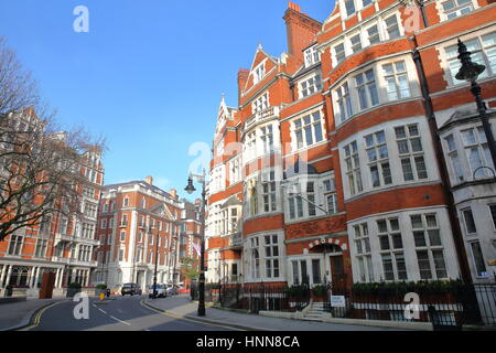 LONDON, UK - FEBRUARY 13, 2017: Red brick Victorian houses facades at Carlos Place in the borough of Westminster Stock Photo