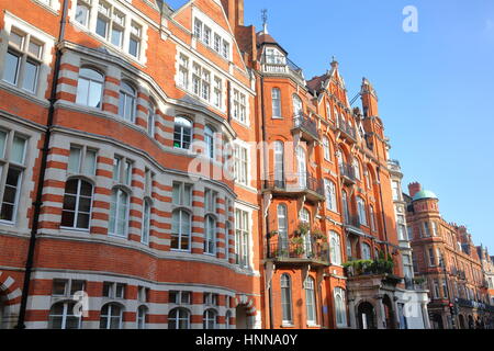 LONDON, UK - FEBRUARY 13, 2017: Red brick Victorian houses facades in Mount Street (borough of Westminster) Stock Photo