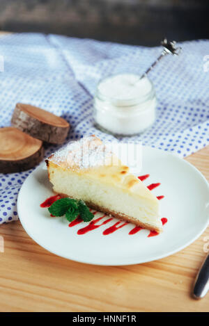 triangle cheese cakes in cafe. On a wooden table Stock Photo