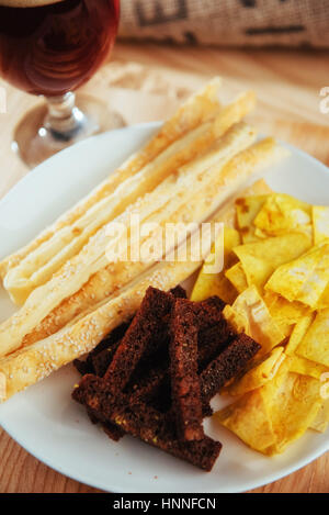 chips, crispy crackers of black bread with sesame and sticks Stock Photo