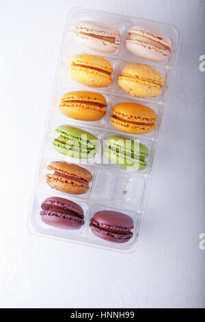 Multicolored Macarons in Box placed on a white background Stock Photo