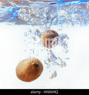 Bubbles forming in blue water after kiwi Stock Photo