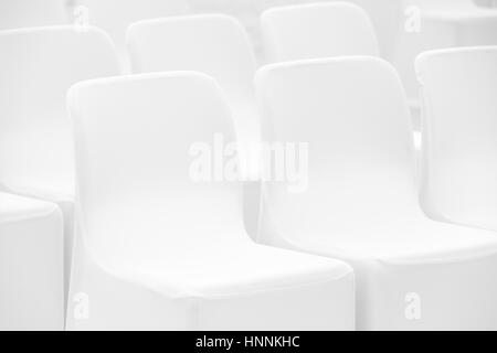 Soft white chairs stand in a row, photo with selective focus Stock Photo