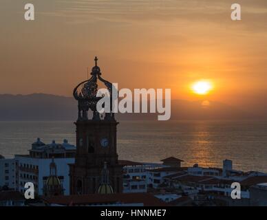 A beautiful sunset viewed from near the Lady of Guadalupe church in Puerto Vallarta, Mexico. Stock Photo