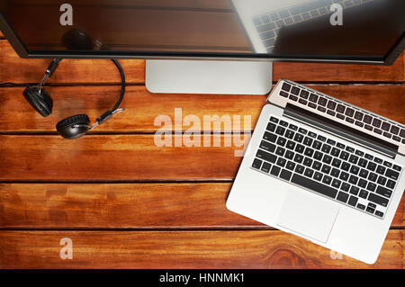 Computer wooden desk view from top. Modern laptop with big screen for photographer Stock Photo