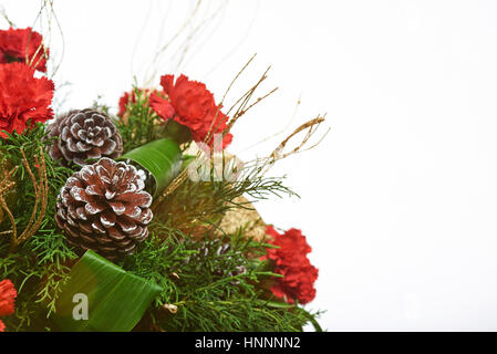 Christmas pine decoration with flowers isolated on white background Stock Photo