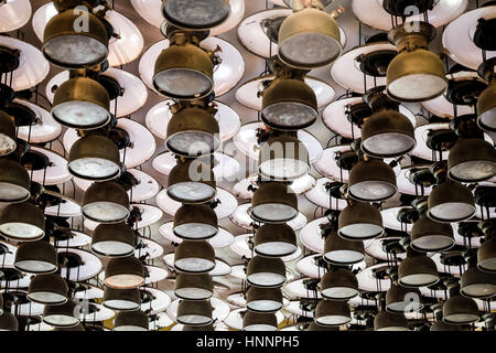 Old storm lanterns hang under the ceiling Stock Photo