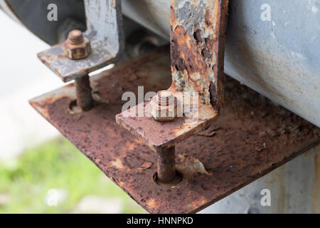 Dirty cast iron saddle clamp for steel pipe connect from pump into the lake within public park Stock Photo