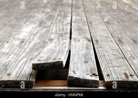 Exterior pine wooden floor bending due to Climate Change, front focus blurred background. Stock Photo
