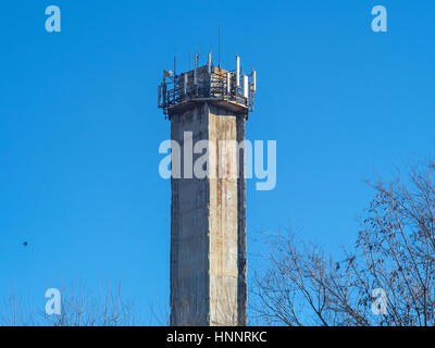 A huge factory pipe on a background of blue sky Stock Photo