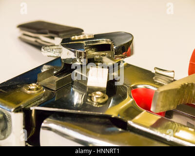 The stapler, pliers and a wrench on a white background Stock Photo