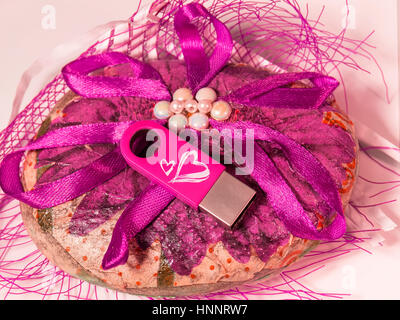 Pink USB flash drive with hearts on the beautiful figure Stock Photo