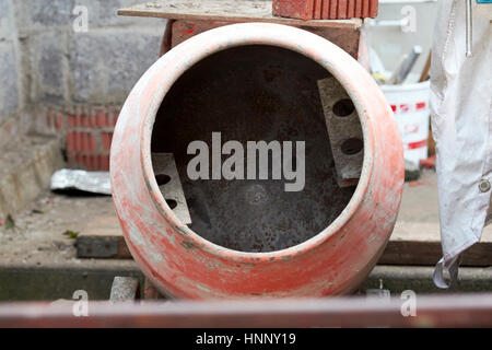old used cement mixer on an extension household construction site in the uk Stock Photo