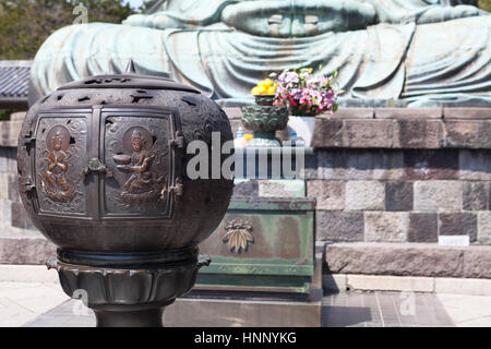 KAMAKURA, JAPAN - CIRCA APR, 2013: Japanese steel burning place for candles is near Great Buddha. Kotoku-in is a Buddhist temple in the city of Kamaku Stock Photo