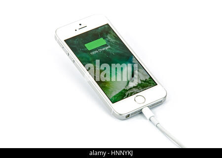Krynica, Poland - February 13, 2017: Presentation of charging basttery in new model iPhone SE Silver 16GB from Apple Inc. Stock Photo