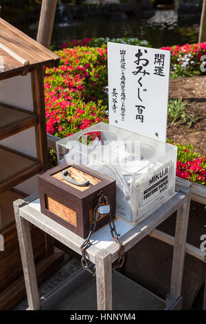 KAMAKURA, JAPAN - CIRCA APR, 2013: Boxes with fortune papers are in the Hasedera shrine. The Hase-kannon (Hase-dera) is one of the Buddhist temples in Stock Photo