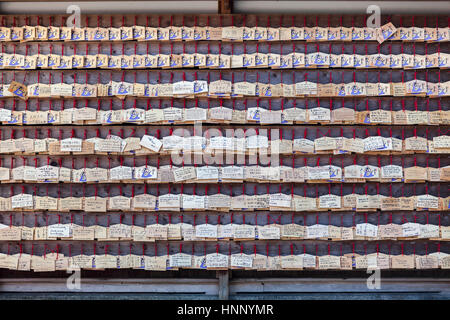 KAMAKURA, JAPAN - CIRCA APR, 2013: Large wall  with fortune wooden plates is in the Hasedera shrine as a background. The Hase-dera is one of the Buddh Stock Photo