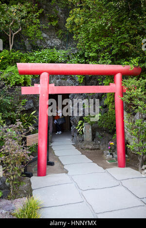 KAMAKURA, JAPAN - CIRCA APR, 2013: Red gate torii is on the entrance in the Benten-do Hall and Benten-kutsu Cave. The Hasedera shrine (Hase-dera) is o Stock Photo